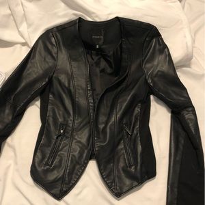 Cropped faux leather jacket with zipper pockets and stretchy side panels